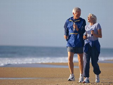 walking couple on the beach - massage therapy